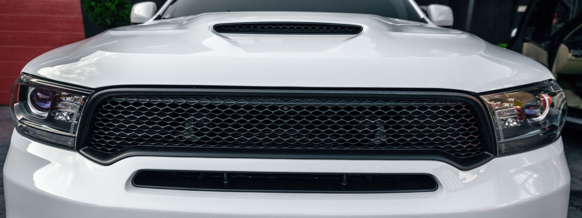 What is a front grill and what are its functions on a vehicle?