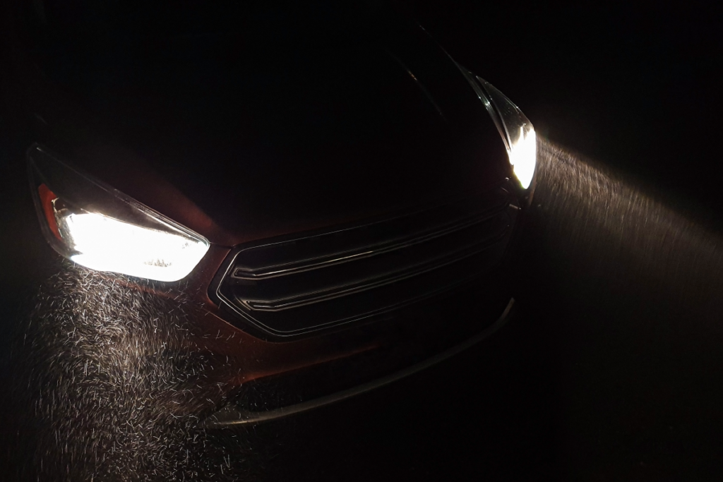 Car headlights shine during heavy snowfall 
lighting
car lighting
headlights 
car lights
automotive
safety 
Endego